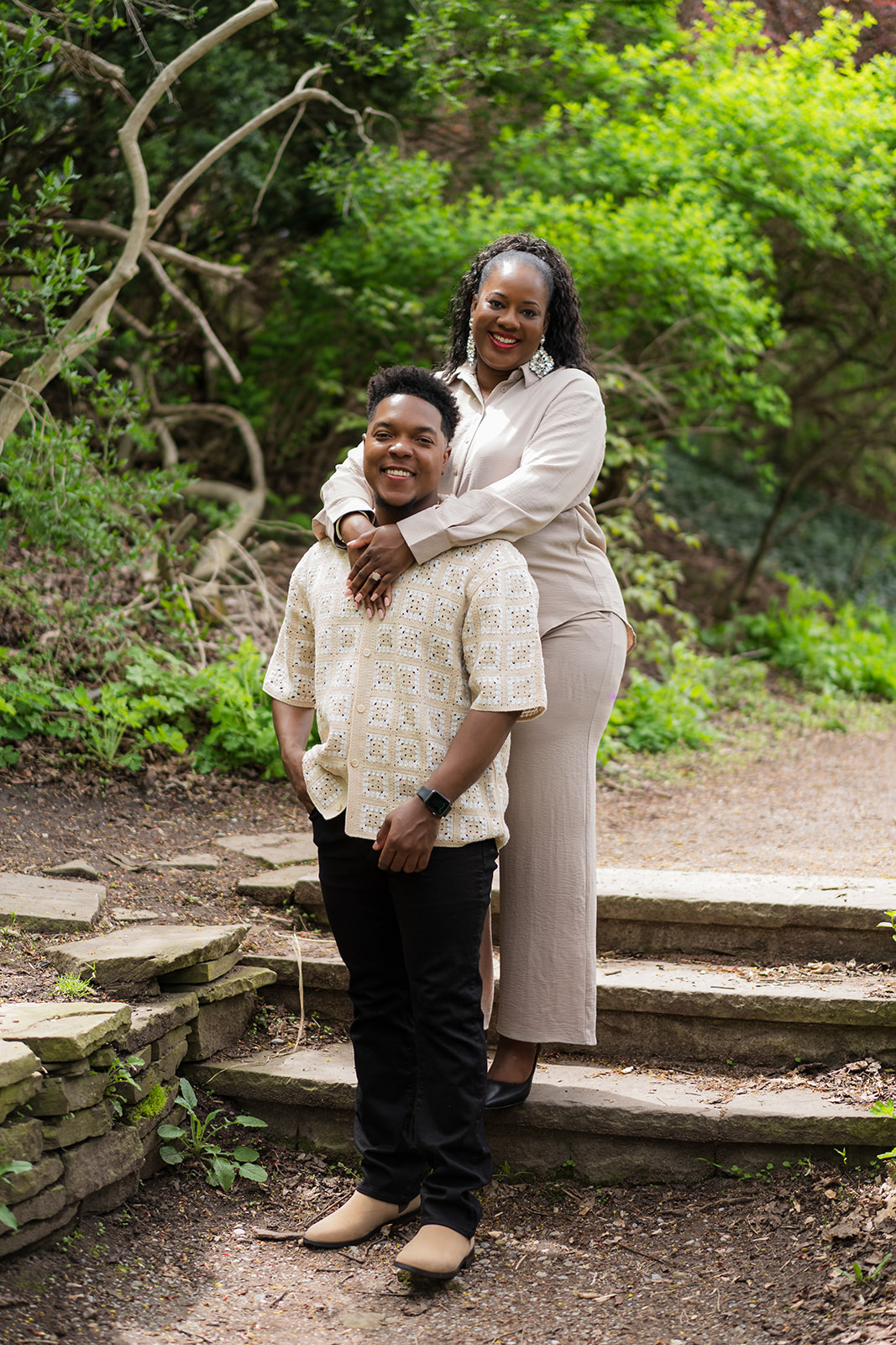 TJ and Deval's engagement portrait on stone garden steps